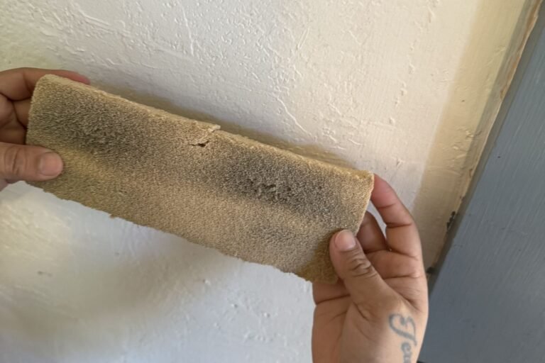 Dry chemical sponge streaked gray with soot after one pass on a white wall - smoke damage restoration in Camarillo, CA