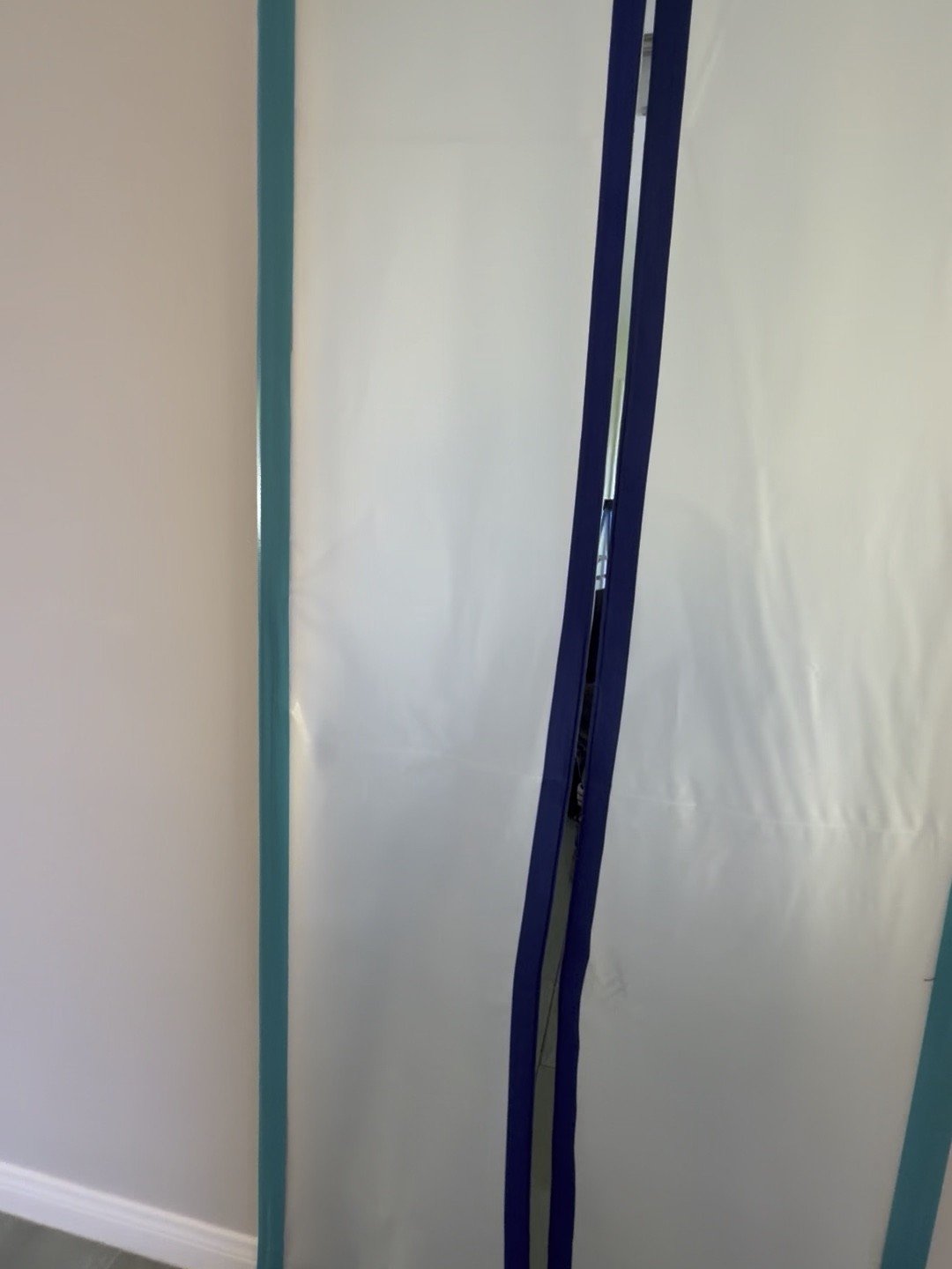 Sealed zipper containment door isolating the work area during mold remediation in a Woodland Hills, CA home — Instant Restoration.