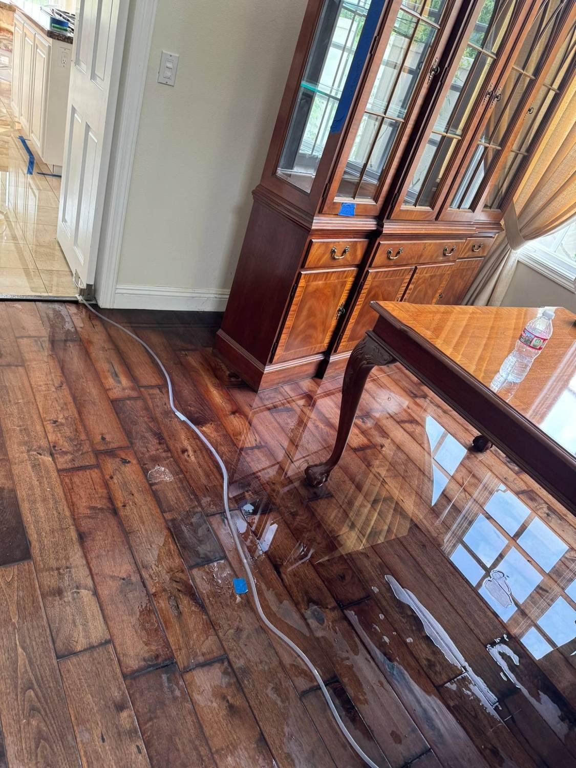 Water spreading across hardwood flooring after a major leak in a Calabasas, CA home.