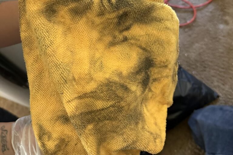Yellow microfiber cloth streaked black with soot from a wall that looked clean - smoke odor removal in Camarillo, CA