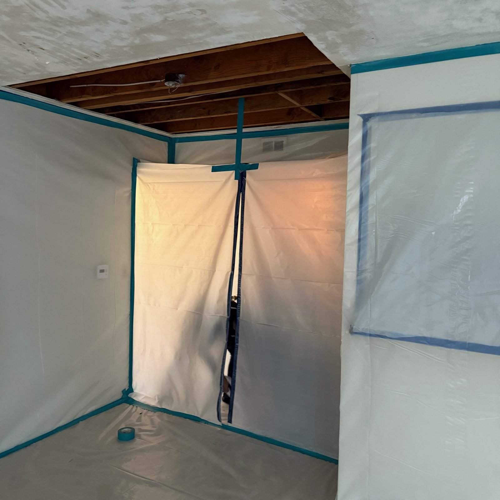 Instant Restoration job photo in Arcadia, CA: Zipper-door containment chamber under exposed ceiling joists, clean and bright