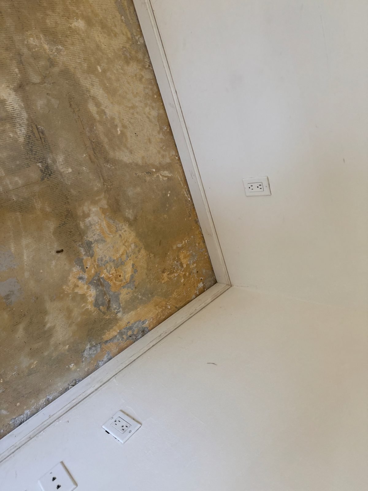 Water-damaged flooring removed down to the bare concrete slab before rebuild - Malibu, CA